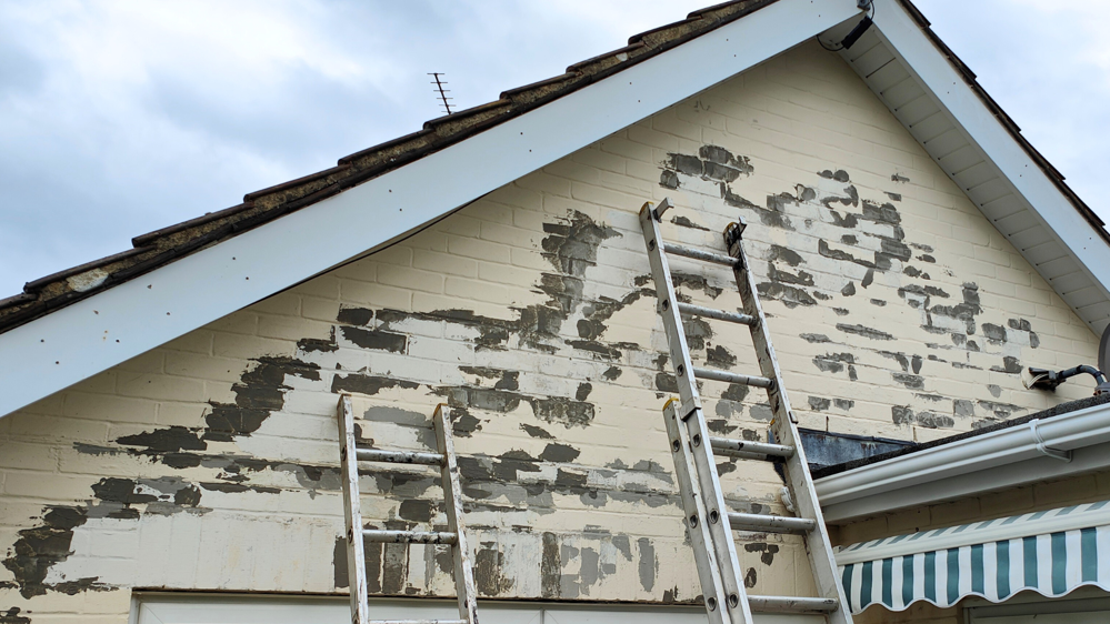 Peeling paint on an external wall of a house